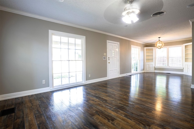 1109 Sayles Blvd, Abilene, TX 79605 - unfurnished living room featuring a textured ceiling, a chandelier, a ceiling fan, dark wood-style floors, and ornamental molding