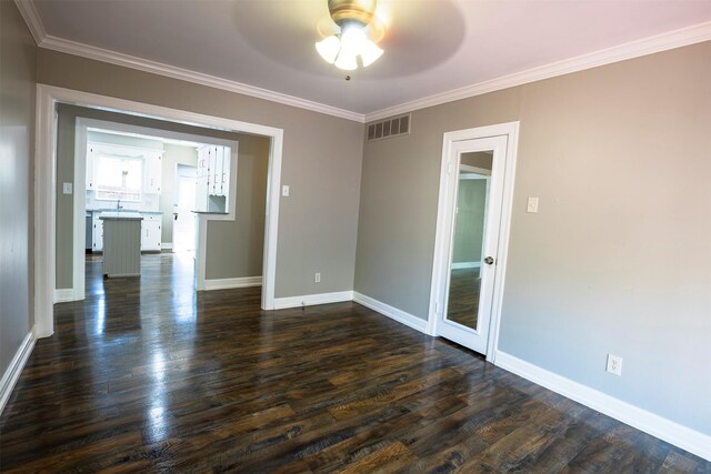 1109 Sayles Blvd, Abilene, TX 79605 - spare room featuring ceiling fan, dark wood-style floors, ornamental molding, and baseboards