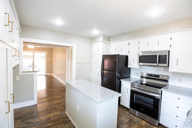 1109 Sayles Blvd, Abilene, TX 79605 - kitchen featuring stainless steel appliances, a center island, light stone counters, baseboards, and dark wood-style floors