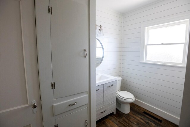 1109 Sayles Blvd, Abilene, TX 79605 - bathroom featuring wood finished floors, vanity, and toilet