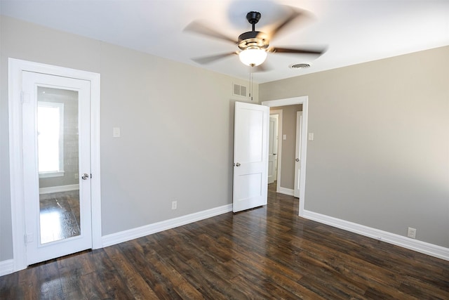 1109 Sayles Blvd, Abilene, TX 79605 - unfurnished room with ceiling fan, dark wood-type flooring, and baseboards