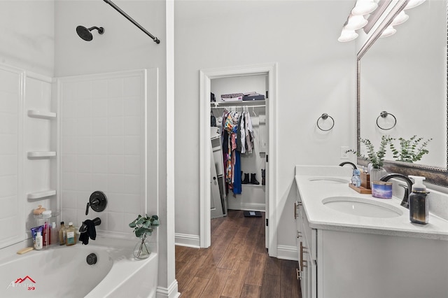 608 Ives Way, Haughton, LA 71037 - full bathroom featuring double vanity,  shower combination, wood finished floors, a spacious closet, and baseboards