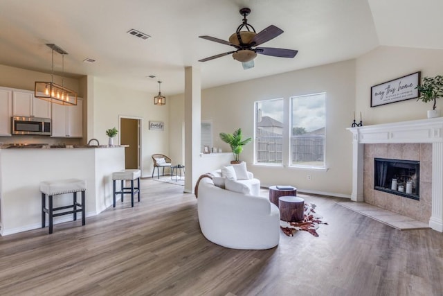 3137 Bent Oak Dr, Mesquite, TX 75181 - living room with wood finished floors, baseboards, ceiling fan, and a tile fireplace