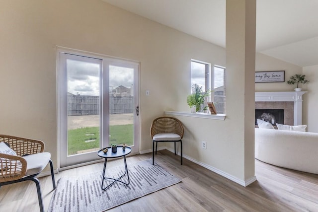 3137 Bent Oak Dr, Mesquite, TX 75181 - sitting room featuring wood finished floors, baseboards, a fireplace, and vaulted ceiling