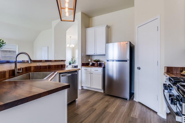 3137 Bent Oak Dr, Mesquite, TX 75181 - kitchen with appliances with stainless steel finishes, a sink, dark wood finished floors, wood counters, and white cabinets