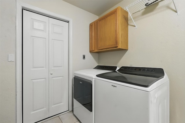 9816 County Road 603c, Burleson, TX 76028 - laundry area with independent washer and dryer, cabinet space, and light tile patterned floors