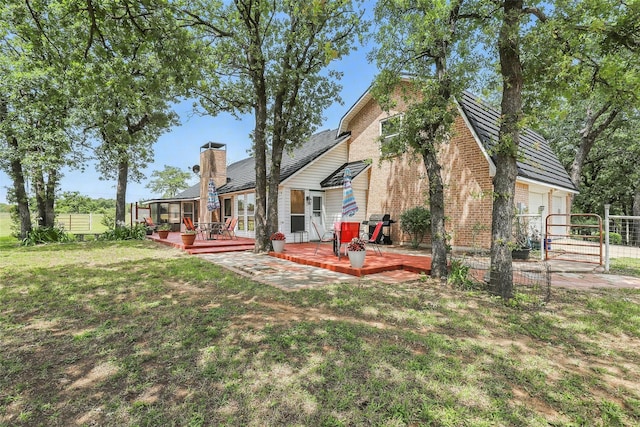 9816 County Road 603c, Burleson, TX 76028 - rear view of house featuring a wooden deck, brick siding, and a chimney