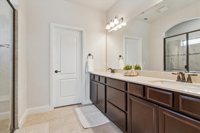 1029 Spring Falls Dr, Mckinney, TX 75071 - bathroom with a shower stall, double vanity, tile patterned flooring, and baseboards