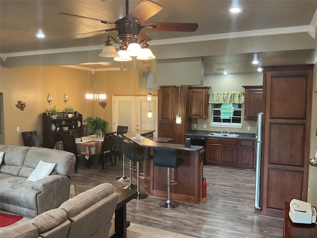 322 Farm Rd Unit 2283, Clarksville, TX 75426 - kitchen featuring a ceiling fan, a breakfast bar area, light wood finished floors, a sink, and open floor plan