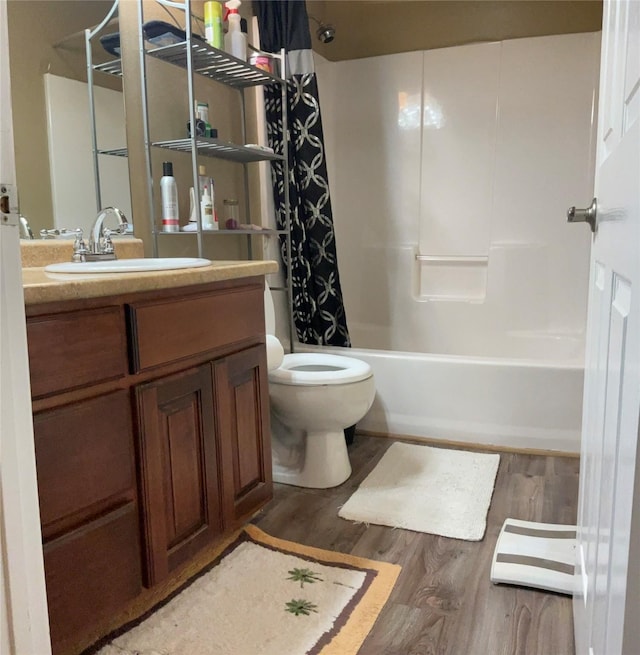 322 Farm Rd Unit 2283, Clarksville, TX 75426 - full bathroom with wood finished floors, toilet, vanity, and shower / tub combo with curtain