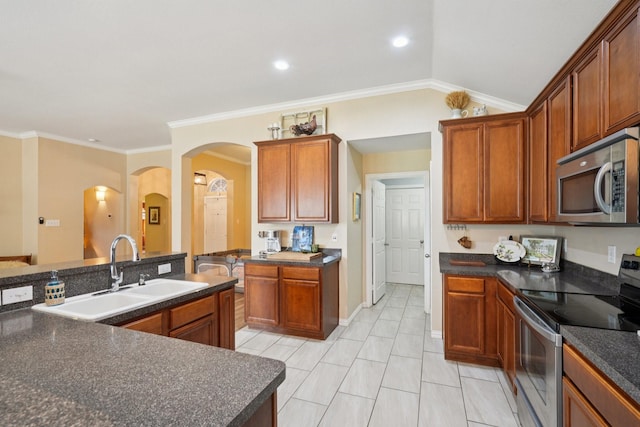 2408 Buffalo Run, Burleson, TX 76028 - kitchen featuring appliances with stainless steel finishes, a sink, arched walkways, dark countertops, and vaulted ceiling