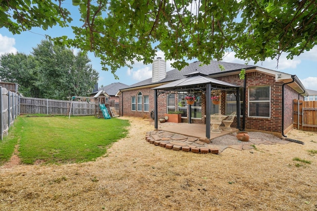 2408 Buffalo Run, Burleson, TX 76028 - back of house with a playground, a patio, a gazebo, brick siding, and a chimney