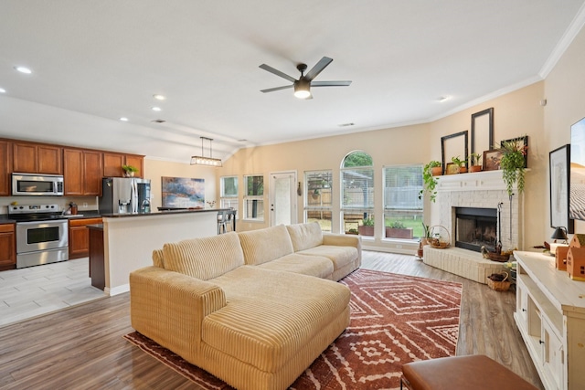 2408 Buffalo Run, Burleson, TX 76028 - living room with light wood-style flooring, a brick fireplace, crown molding, a ceiling fan, and recessed lighting