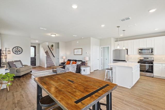 1608 Star Fleet Dr, Haslet, TX 76052 - dining room with light wood-style flooring, stairway, baseboards, and recessed lighting