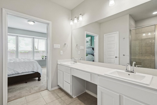 1608 Star Fleet Dr, Haslet, TX 76052 - ensuite bathroom featuring double vanity, tile patterned flooring, a shower stall, and baseboards