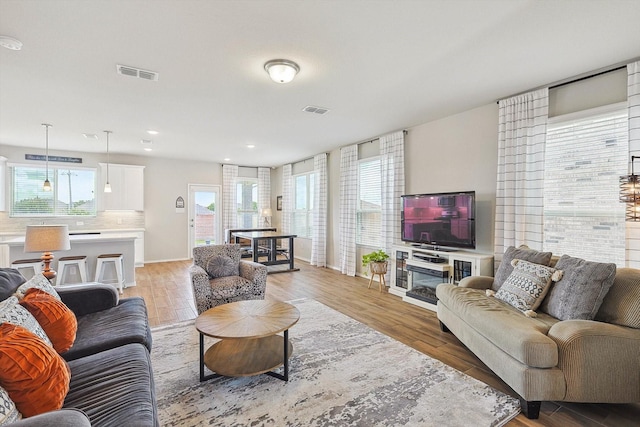 1608 Star Fleet Dr, Haslet, TX 76052 - living room with baseboards, light wood-style floors, and recessed lighting