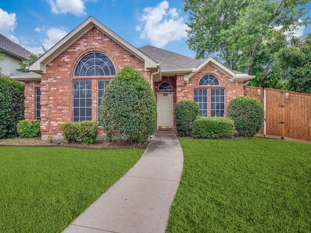 18851 Park Grove Ln, Dallas, TX 75287 - view of front of house with brick siding, a front lawn, a gate, and a shingled roof