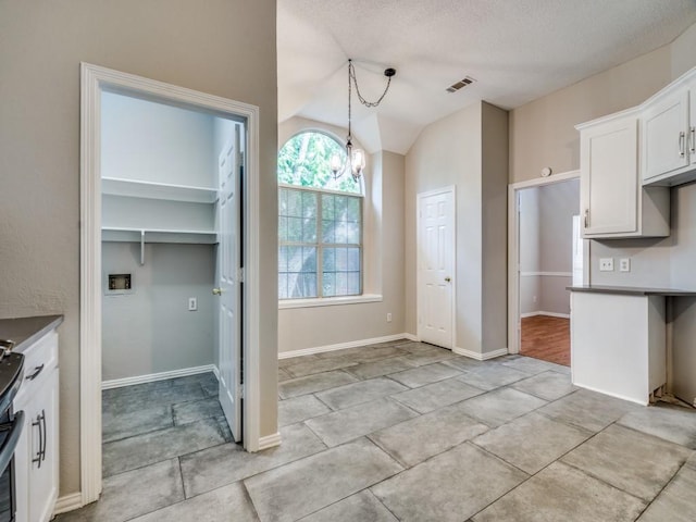 18851 Park Grove Ln, Dallas, TX 75287 - kitchen featuring white cabinetry, pendant lighting, lofted ceiling, light tile patterned flooring, and dark countertops