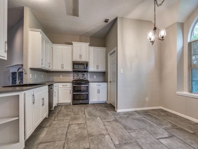 18851 Park Grove Ln, Dallas, TX 75287 - kitchen featuring appliances with stainless steel finishes, a sink, backsplash, a chandelier, and white cabinets