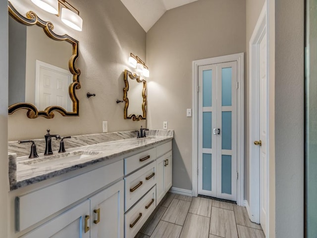 18851 Park Grove Ln, Dallas, TX 75287 - full bath featuring double vanity, lofted ceiling, and baseboards