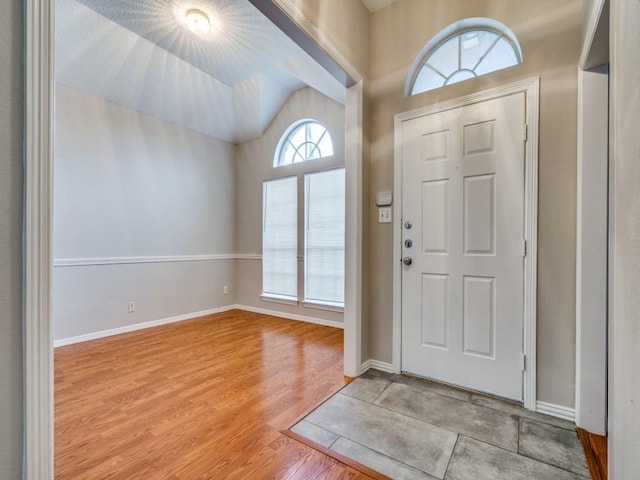 18851 Park Grove Ln, Dallas, TX 75287 - entryway with vaulted ceiling, light wood-style floors, and baseboards
