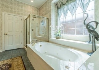 2909 Harkness Dr, Plano, TX 75093 - full bath with a stall shower, a garden tub, healthy amount of natural light, wallpapered walls, and tile patterned flooring