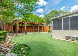 2909 Harkness Dr, Plano, TX 75093 - view of yard with a pergola and a sunroom