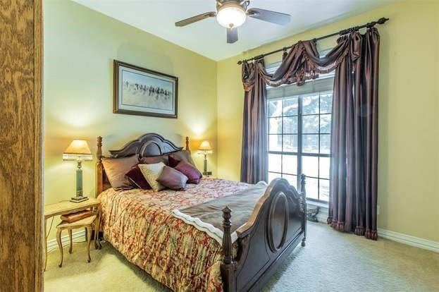 2909 Harkness Dr, Plano, TX 75093 - carpeted bedroom featuring baseboards and a ceiling fan