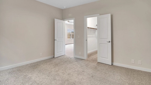 1524 Latimer Ct, Trenton, TX 75490 - unfurnished bedroom featuring light carpet, a walk in closet, baseboards, and a closet