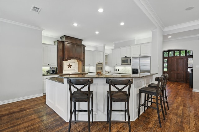 129 Shady Dale Ln, Coppell, TX 75019 - kitchen with appliances with stainless steel finishes, backsplash, recessed lighting, a large island, and dark wood-style floors