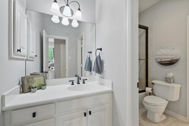 129 Shady Dale Ln, Coppell, TX 75019 - bathroom featuring vanity, toilet, tile patterned floors, bath / shower combo with glass door, and baseboards