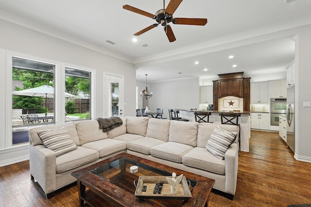 129 Shady Dale Ln, Coppell, TX 75019 - living area featuring recessed lighting, dark wood-style flooring, ceiling fan, crown molding, and a chandelier