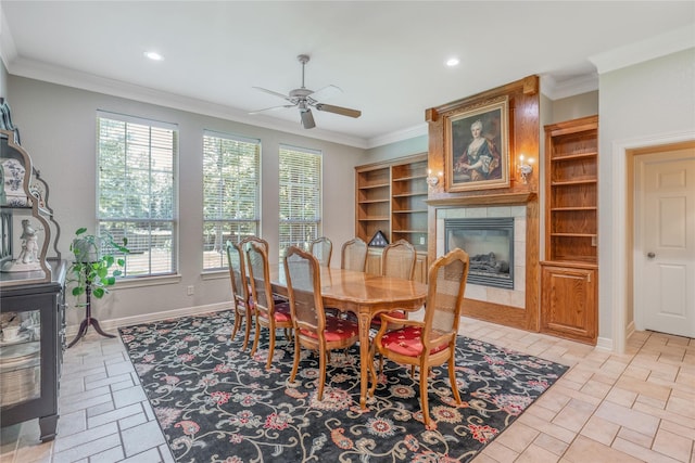 11240 Marsh Wren Cir, Flint, TX 75762 - dining area featuring a ceiling fan, healthy amount of natural light, crown molding, a tiled fireplace, and recessed lighting