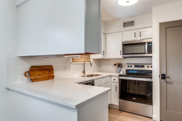 4303 Buena Vista St Unit 206, Dallas, TX 75205 - kitchen with appliances with stainless steel finishes, a sink, white cabinetry, and light countertops