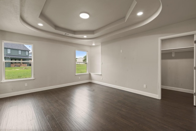 407 Charleston Park Dr, Woodway, TX 76712 - unfurnished bedroom featuring a raised ceiling, wood finished floors, a spacious closet, baseboards, and recessed lighting
