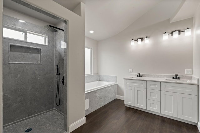 407 Charleston Park Dr, Woodway, TX 76712 - bathroom featuring vaulted ceiling, a bath, walk in shower, wood finished floors, and double vanity