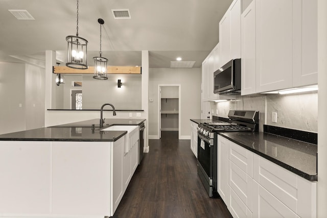 407 Charleston Park Dr, Woodway, TX 76712 - kitchen featuring stainless steel appliances, dark wood-type flooring, recessed lighting, decorative backsplash, and a sink