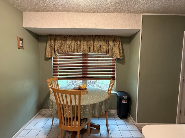 504 Cedar St, Mineral Wells, TX 76067 - dining room with a textured ceiling, light tile patterned flooring, and baseboards