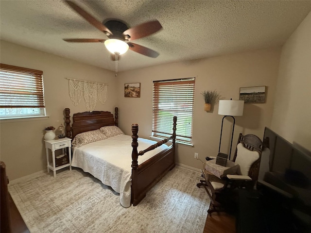 504 Cedar St, Mineral Wells, TX 76067 - bedroom featuring a textured ceiling, a ceiling fan, and baseboards