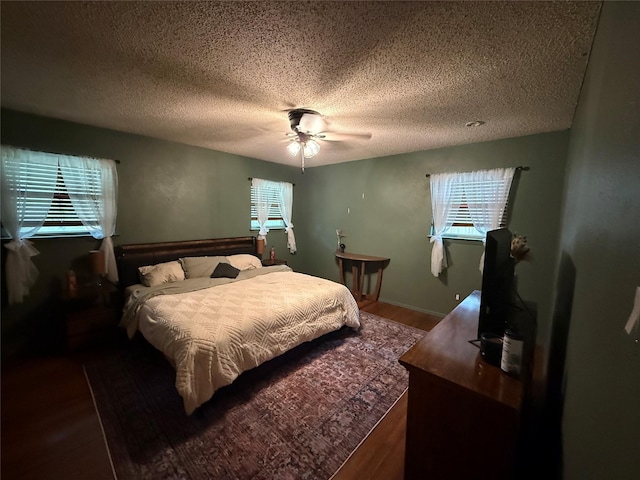 504 Cedar St, Mineral Wells, TX 76067 - bedroom with a textured ceiling, wood finished floors, and a ceiling fan