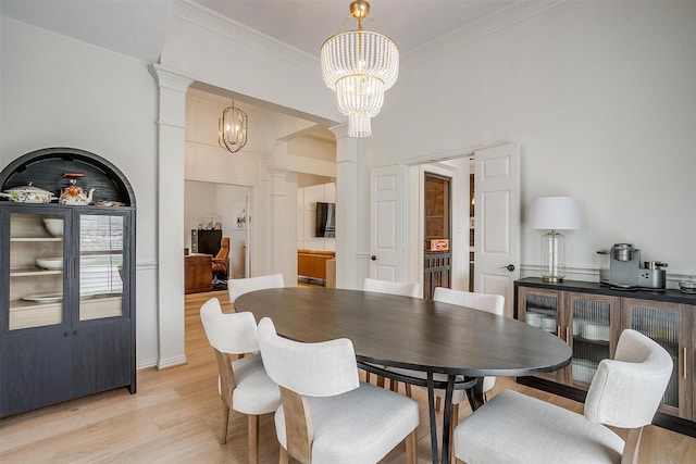 2006 Timber Cove Ct, Weatherford, TX 76087 - dining area featuring a chandelier, decorative columns, ornamental molding, and light wood finished floors