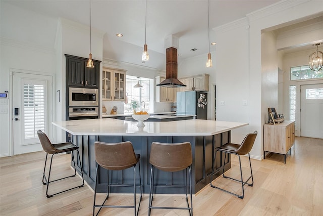 2006 Timber Cove Ct, Weatherford, TX 76087 - kitchen with stainless steel appliances, light wood-style flooring, light countertops, a spacious island, and glass insert cabinets