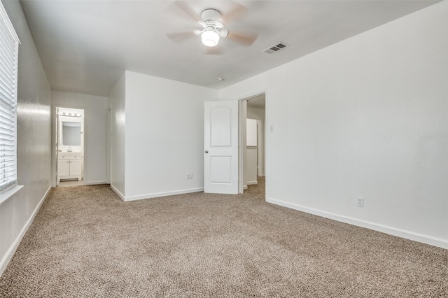 7130 Sorcey Rd, Dallas, TX 75249 - unfurnished bedroom featuring carpet floors, baseboards, ensuite bath, and a ceiling fan