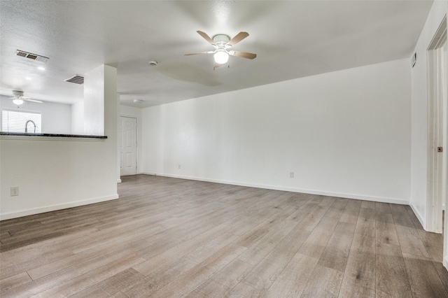 7130 Sorcey Rd, Dallas, TX 75249 - unfurnished living room with a ceiling fan, wood finished floors, and baseboards