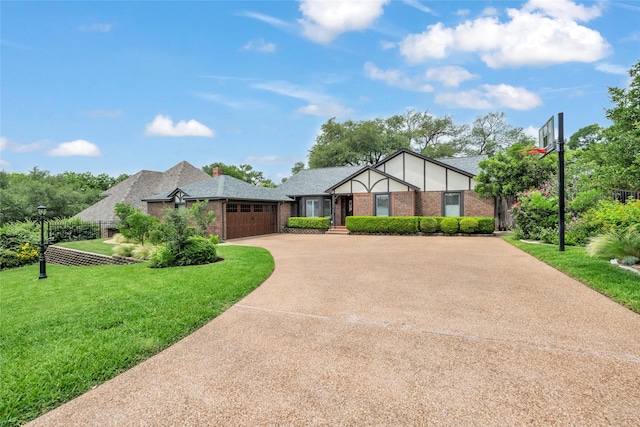 3308 Red Cliff Cir, Temple, TX 76502 - tudor home featuring an attached garage, a front lawn, concrete driveway, brick siding, and roof with shingles