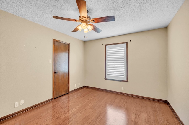 3308 Red Cliff Cir, Temple, TX 76502 - empty room with wood finished floors, ceiling fan, baseboards, and a textured ceiling