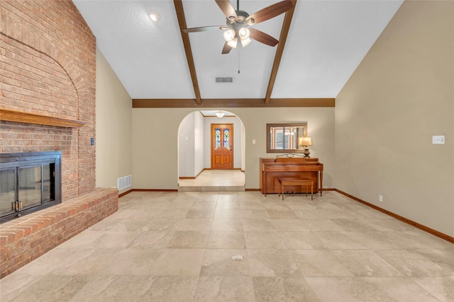 3308 Red Cliff Cir, Temple, TX 76502 - unfurnished living room with a ceiling fan, baseboards, arched walkways, a brick fireplace, and high vaulted ceiling