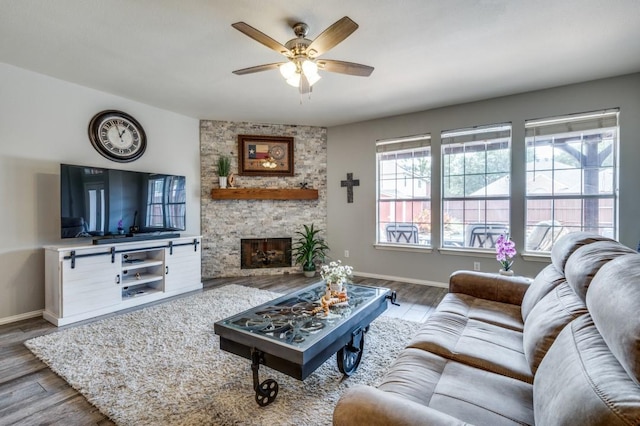 9807 Asheboro St, Frisco, TX 75035 - living area featuring a fireplace, wood finished floors, ceiling fan, and baseboards