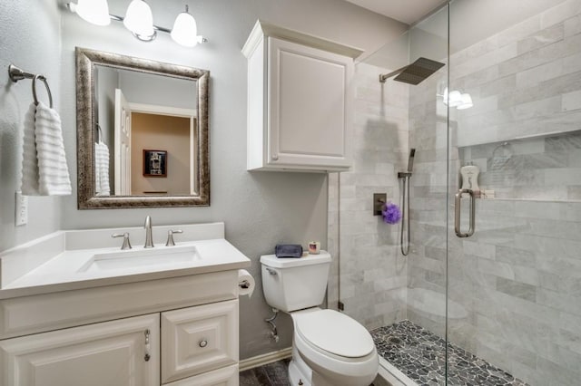 9807 Asheboro St, Frisco, TX 75035 - bathroom featuring toilet, a stall shower, and vanity