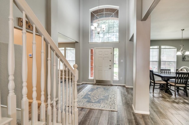 9807 Asheboro St, Frisco, TX 75035 - entryway with a chandelier, wood finished floors, stairs, a towering ceiling, and baseboards